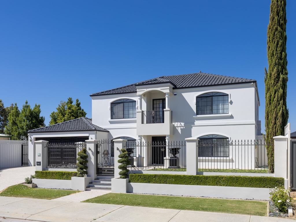 Freshly painted home with wrought iron fence